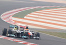 Nico Rosberg passes Narain Karthikeyan