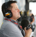 Pirelli's Paul Hembery keeps an eye on the pit lane