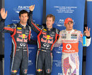 Sebastian Vettel celebrates his 13th pole of the season with Mark Webber and Lewis Hamilton