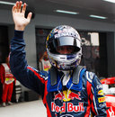 Sebastian Vettel waves after securing his 13th pole of the season