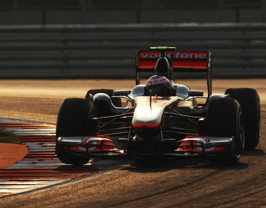 Jenson Button guides his McLaren to second place as the sun starts to set 