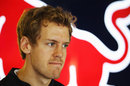 Sebastian Vettel ponders the weekend ahead in the Red Bull garage