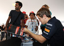 Sebastian Vettel signs autographs on Friday morning