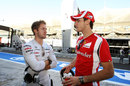 Sam Bird and Jules Bianchi chat in the pit lane