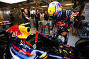 Mark Webber climbs in to his Red Bull ahead of FP1