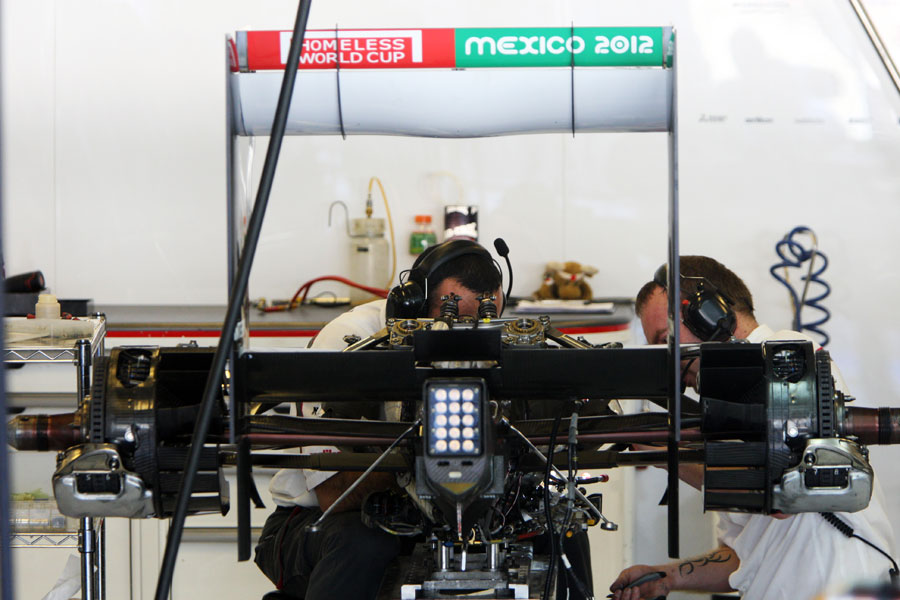 The rear end of Kamui Kobayashi's Sauber being worked on in the garage