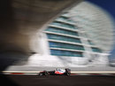 Jenson Button drives under the Yas Hotel