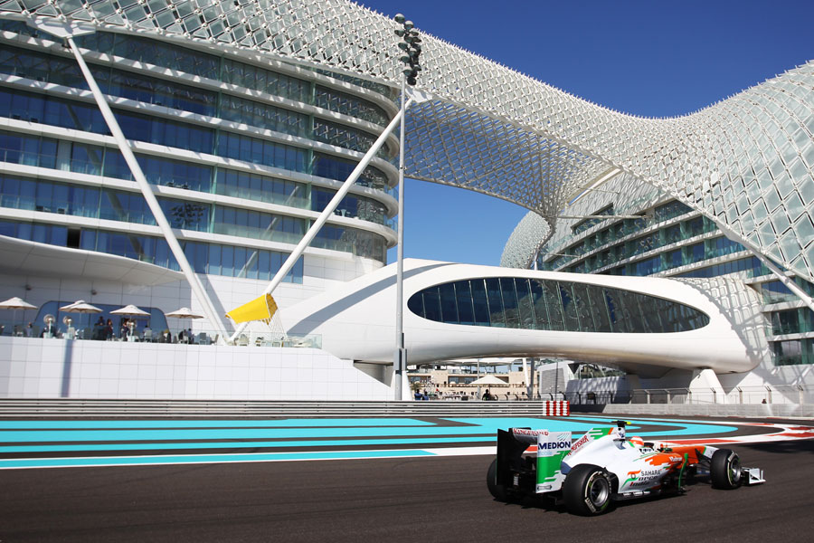 Paul di Resta aims for the apex of turn 18 below the Yas Hotel