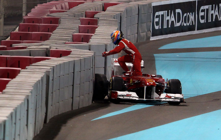Fernando Alonso leaps from his car after spinning off at turn one