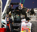 Sebastian Vettel watches on as his Red Bull is craned away