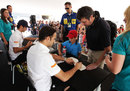 Tonio Liuzzi and Daniel Ricciardo at an autograph signing session on Saturday morning