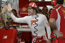 Fernando Alonso greets his mechanics in the Ferrari garage