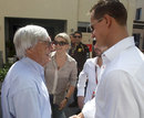 Bernie Ecclestone greets Michael Schumacher in the paddock on Sunday morning