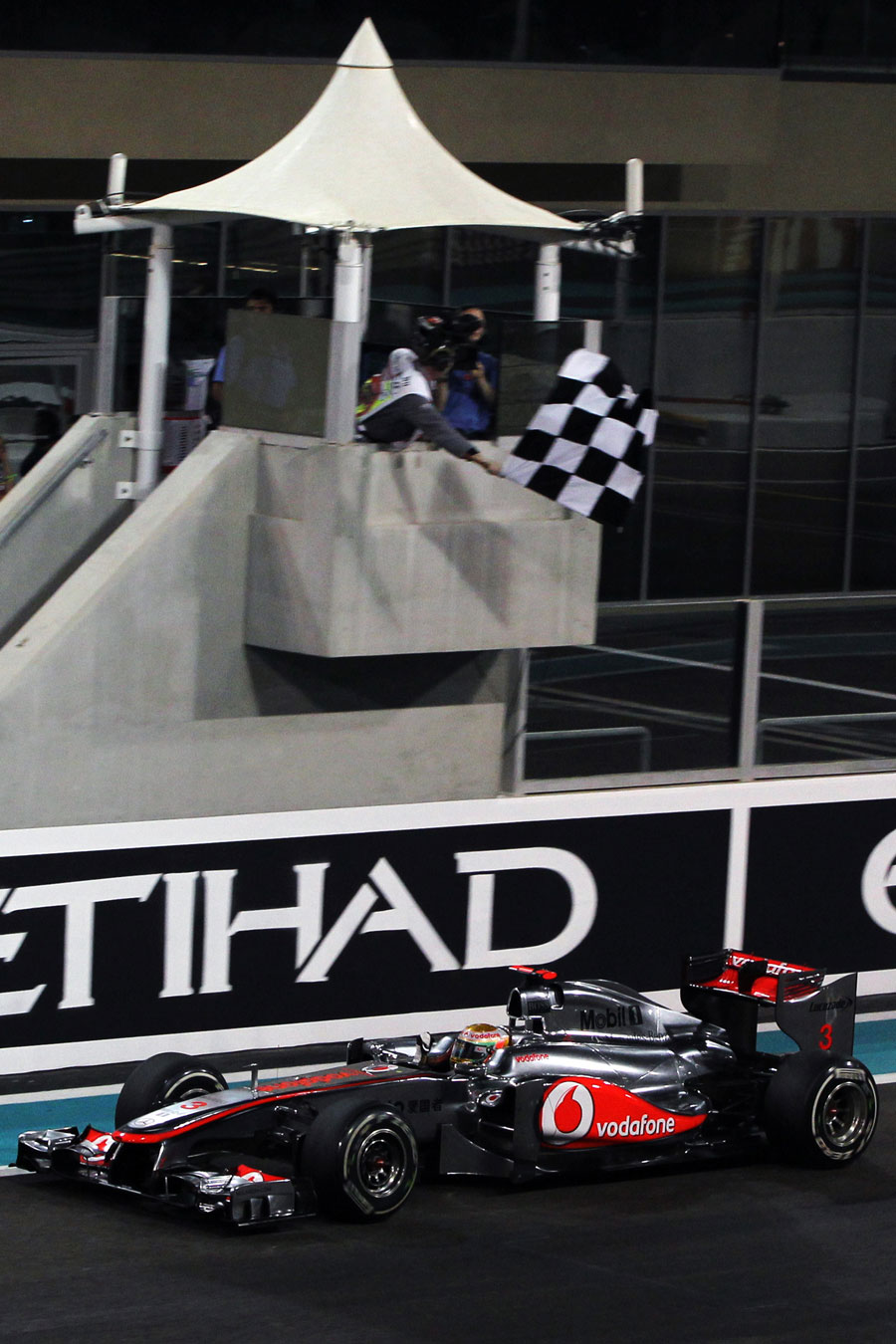 Lewis Hamilton celebrates as he takes the chequered flag