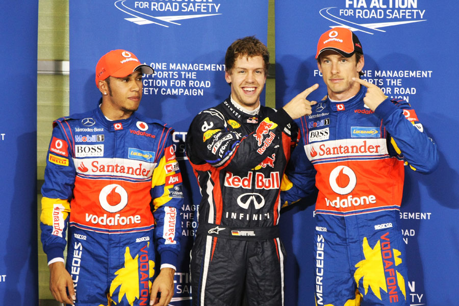 Sebastian Vettel and Jenson Button share a joke over Button's Movember moustache