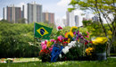A Brazilian flag waves next to floral tributes on the grave Ayrton Senna
