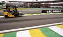 A Force India mechanic moves equipment around the circuit