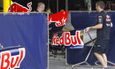 Red Bull mechanics move an engine cover for the RB7