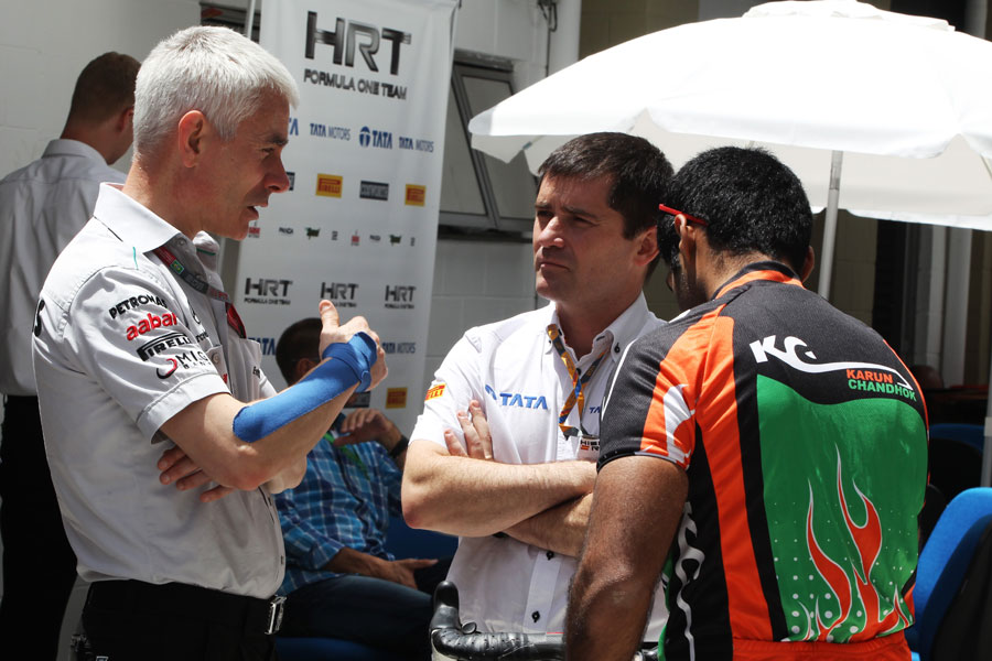 Geoff Willis talks to Antonio Cuquerella and Karun Chandhok in the paddock