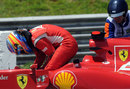 Fernando Alonso climbs out of his Ferrari after stopping with an engine problem