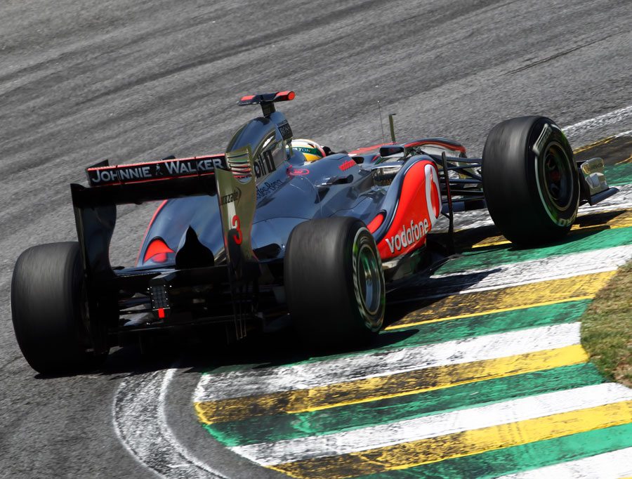 Lewis Hamilton rides the kerbs in his McLaren
