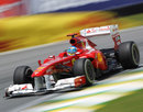 Fernando Alonso slides his Ferrari through the first corner