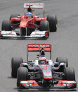 Jenson Button holds off Fernando Alonso early in the race