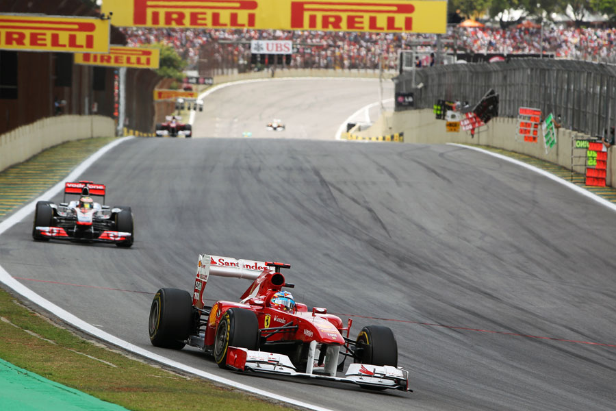 Fernando Alonso leads Lewis Hamilton in to turn one