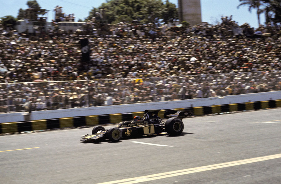 Emerson Fittipaldi passes the enthusiastic home crowd in the main grandstand