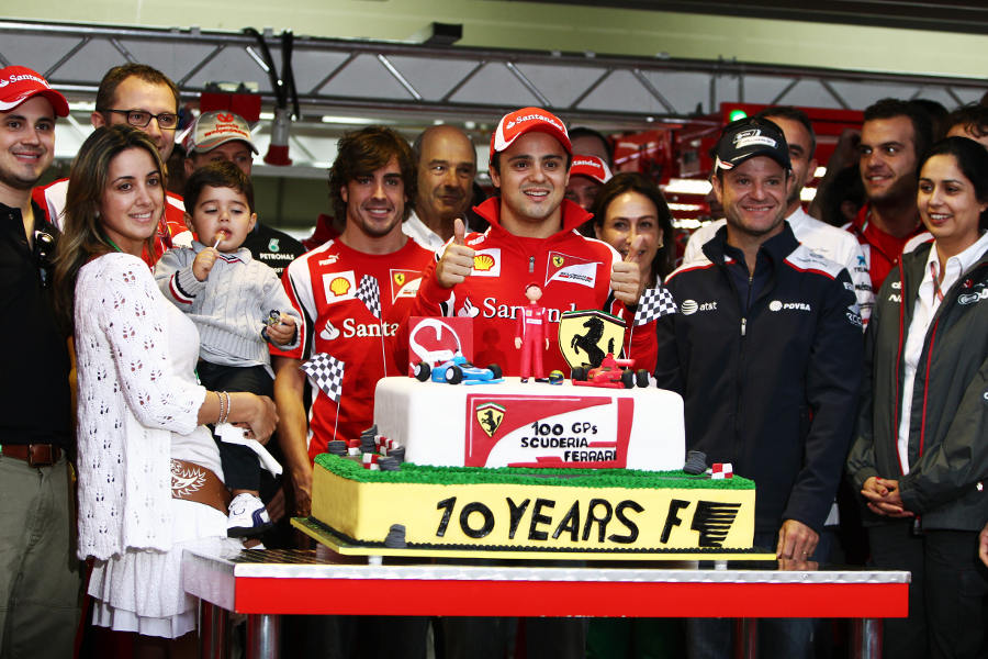 Felipe Massa receives a cake to mark 100 grand prix starts for Ferrari and ten seasons in Formula One