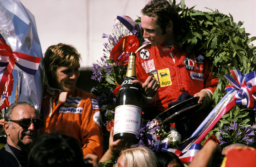 Niki Lauda and James Hunt celebrate on the podium after the race