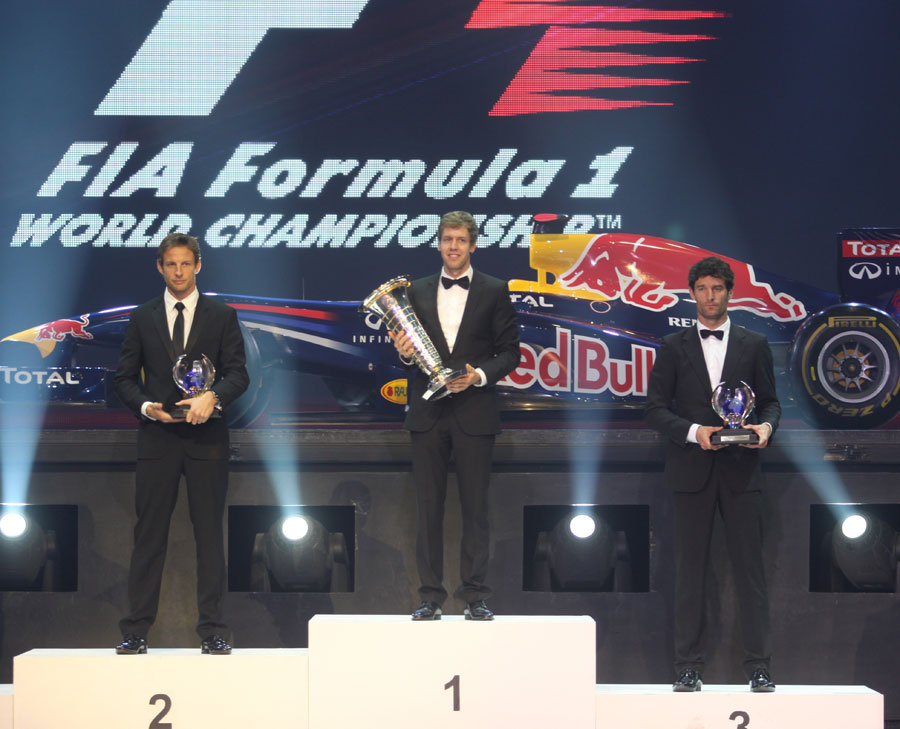 Sebastian Vettel, Jenson Button and Mark Webber receive their trophies for finishing first, second and third in the 2011 drivers' championship