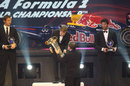 Sebastian Vettel receives his drivers' championship trophy from Jean Todt