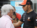 Bernie Ecclestone talks to Lewis Hamilton in the paddock