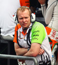 Force India technical director Andrew Green watches proceedings in the garage from the pit wall