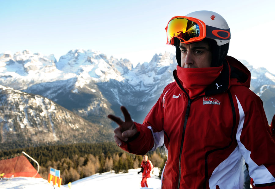 Fernando Alonso waves before going skiing at Ferrari's annual media event Wrooom