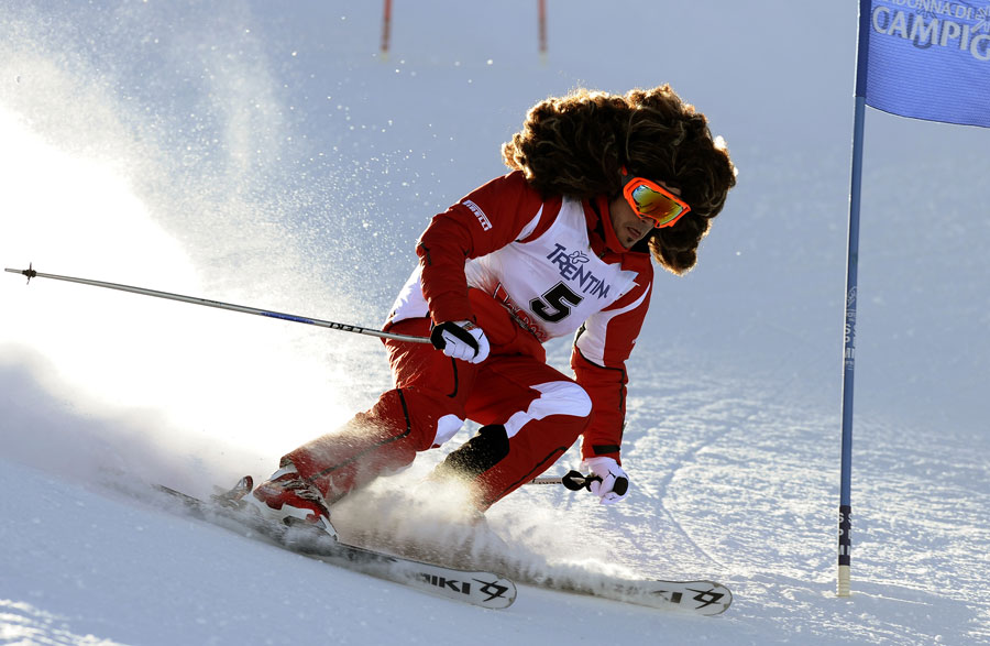 Fernando Alonso sports a large wig during a ski race at Ferrari's annual media event Wrooom