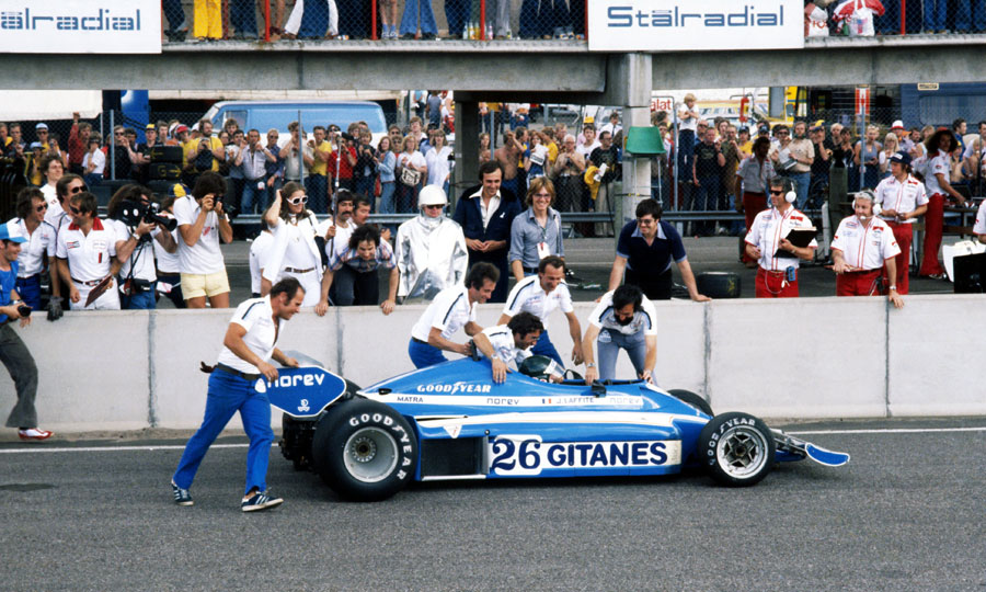 Jacques Laffite is congratulated by his Ligier team after taking victory