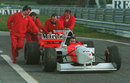 McLaren mechanics push Nigel Mansell back down the pit lane after he spun off during his first test for the team