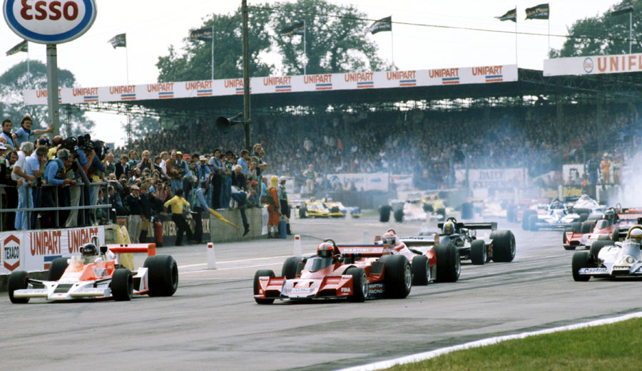 Pole-sitter James Hunt suffers a poor start and is beaten off the line by John Watson