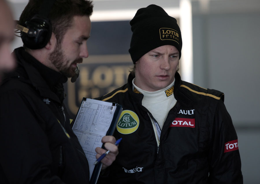 Kimi Raikkonen listens to his engineers in the Lotus garage