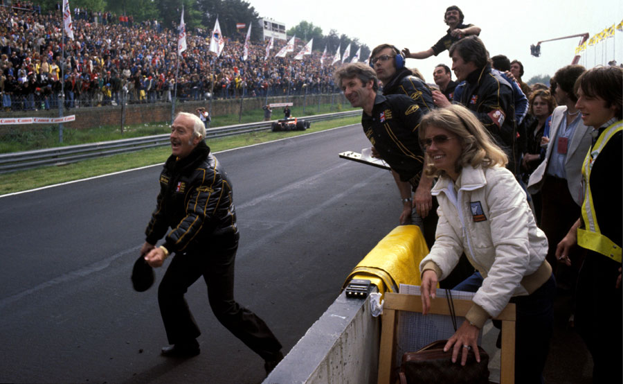 Colin Chapman prepares to celebrate victory in his customary style