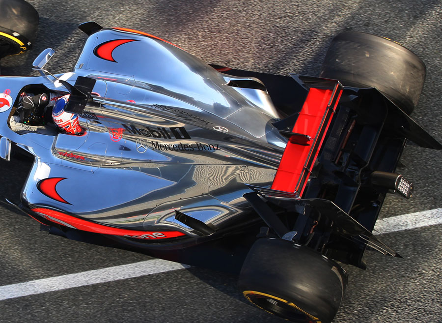 Jenson Button leaves the garage in the McLaren MP4-27 with exhaust channels