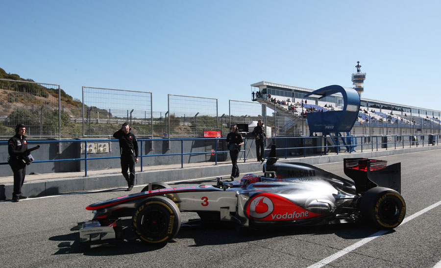 Jenson Button pulls up outside the McLaren garage