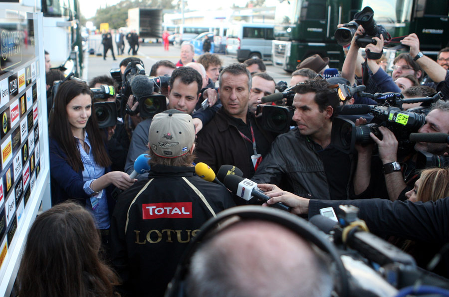 Kimi Raikkonen talks to the press after his first day back in an F1 car