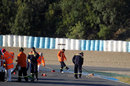 Marshals sweep gravel off the circuit during a red flag period after Kimi Raikkonen ran wide