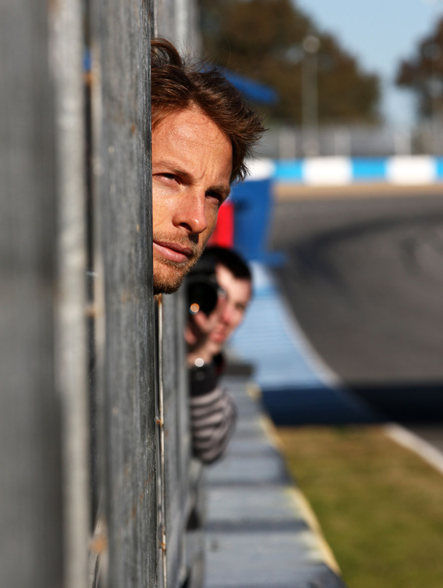 Jenson Button takes time to observe the other cars on track