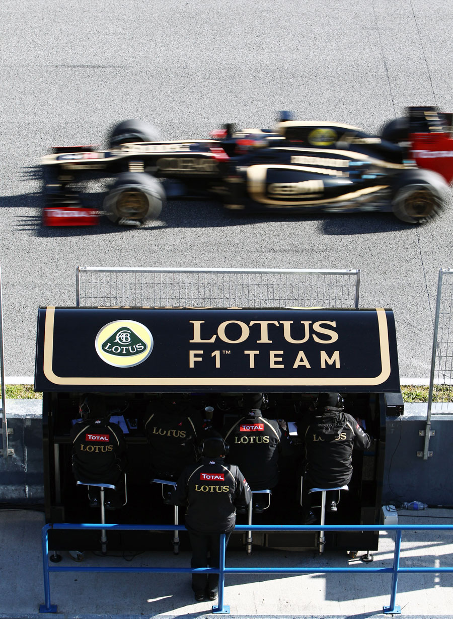 Romain Grosjean completes another lap in front of his pit wall