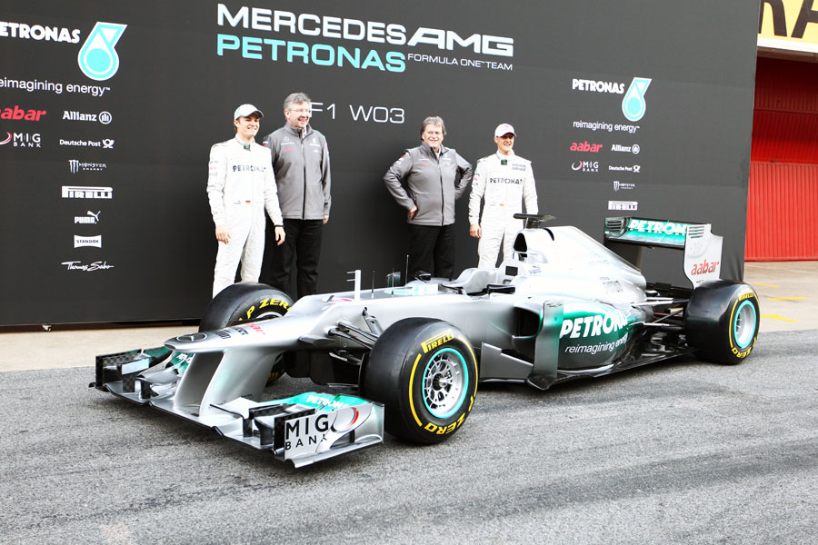 Nico Rosberg, Ross Brawn, Norbert Haug and Michael Schumacher pose with the new W03