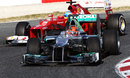 Fernando Alonso looks for a way past Michael Schumacher on intermediate tyres